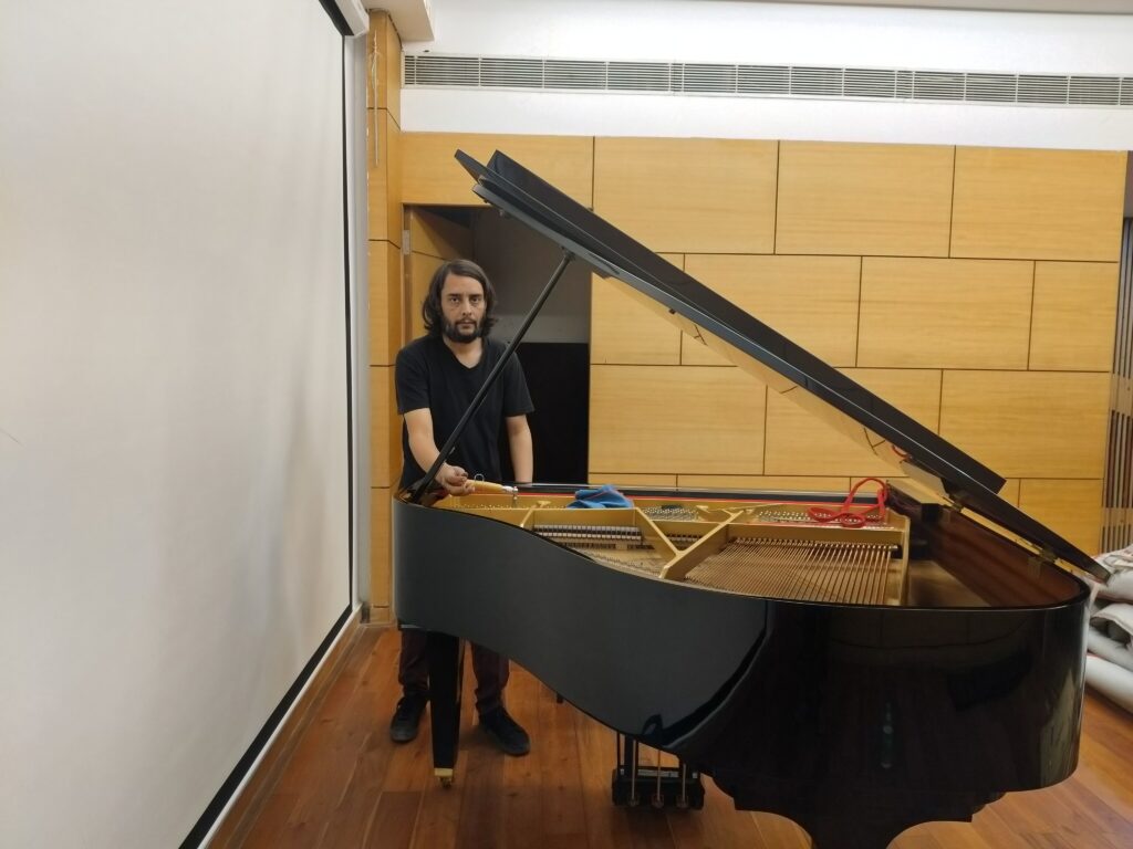 Rajneesh Vohra Tuning on grand piano at korean culture center